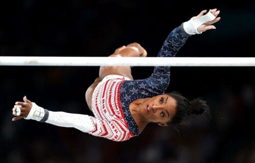 Simone Biles competes on the uneven bars in the women's team final at the Paris Olympics.