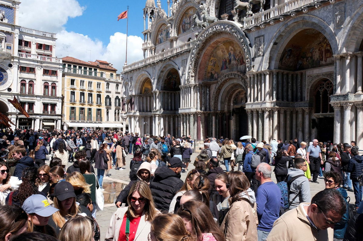 <i>Manuel Silvestri/Reuters via CNN Newsource</i><br/>Tourists in St. Mark's Square