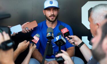 The Kansas City Royals' Paul DeJong talks to reporters shortly after being traded to the team from the Chicago White Sox.