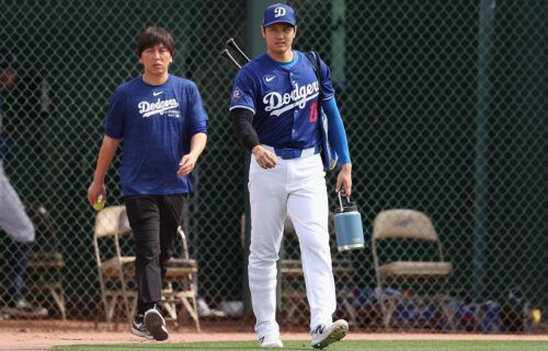 Shohei Ohtani #17 of the Los Angeles Dodgers and interpreter Ippei Mizuhara arrive to a game against the Chicago White Sox at Camelback Ranch on February 27