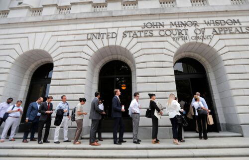 People wait in line to enter the 5th Circuit Court of Appeals in New Orleans in Jan. 2019.