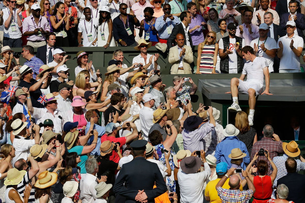 <i>Anja Niedringhaus/Pool/Getty Images via CNN Newsource</i><br/>Murray climbs to his friends and family after winning the Wimbledon title in 2013.