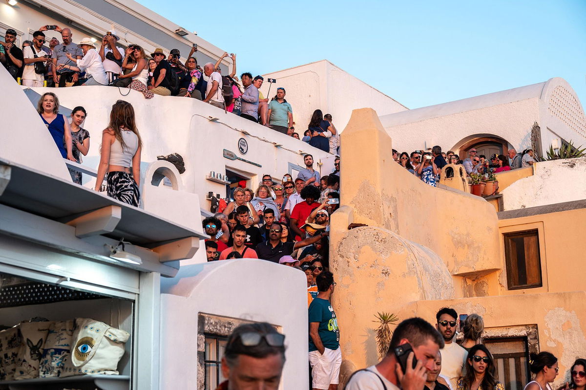 <i>Xavier Duvot/Hans Lucas/AFP/Getty Images via CNN Newsource</i><br/>The battle for the best balcony spot gets underway in Oia on June 30.