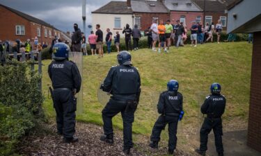 Riot police monitor a protest in Sunderland