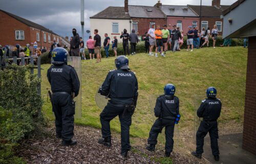 Riot police monitor a protest in Sunderland