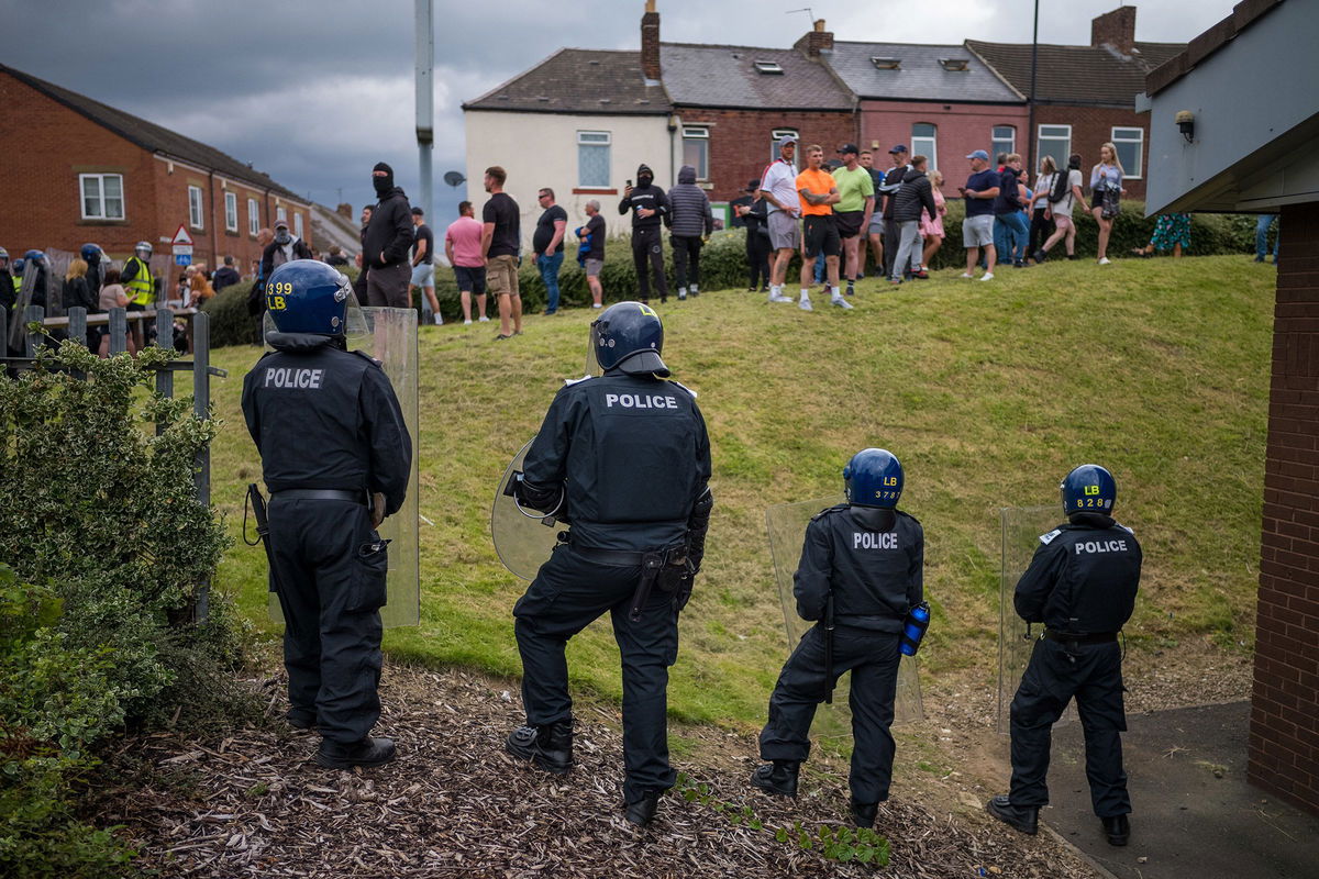 <i>Ian Forsyth/Getty Images via CNN Newsource</i><br/>Riot police monitor a protest in Sunderland