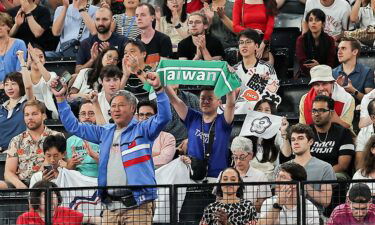 Journalists reported seeing a man holding a green Taiwan banner being removed from an Olympic badminton game mid-match.