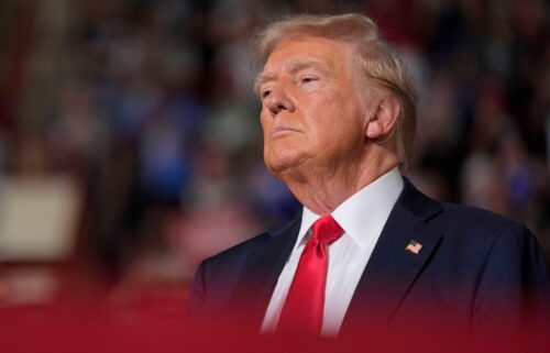 Former President Donald Trump waits on stage to speak at a campaign rally on Wednesday