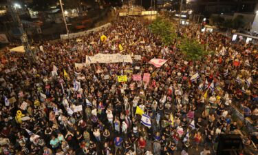 Supporters and relatives of Israelis held hostage by Palestinian militants in the Gaza Strip since October lift placards during a rally to demand their release in Tel Aviv on August 3.