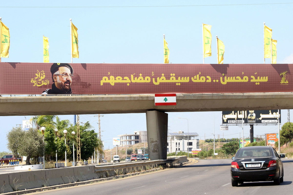 <i>Mahmoud Zayyat/AFP/Getty Images via CNN Newsource</i><br/>Hezbollah flags are erected along with a banner showing assassinated Hezbollah commander Fuad Shukr in southern Lebanon.