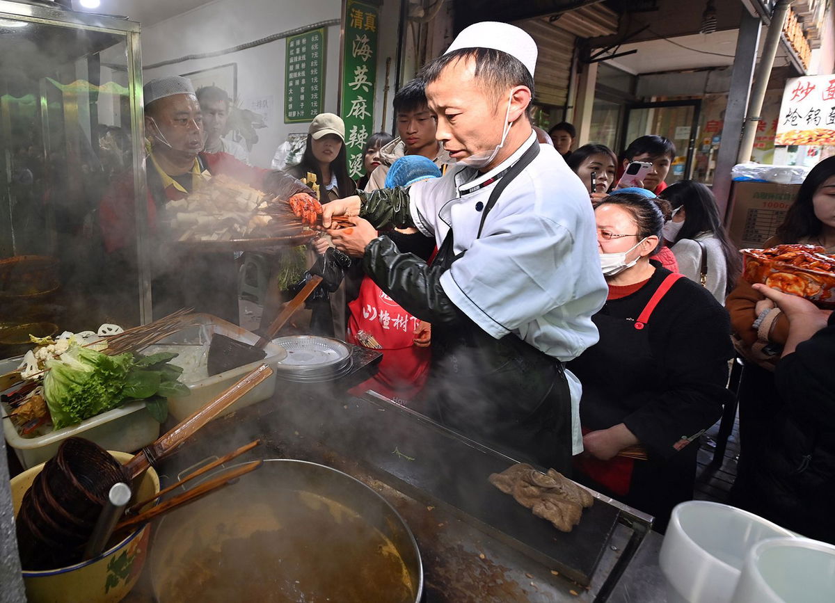 <i>Jiumei Danzeng/China News Service/VCG/Getty Images via CNN Newsource</i><br/>A staff member cooks Tianshui Spicy Hot Pot on March 14