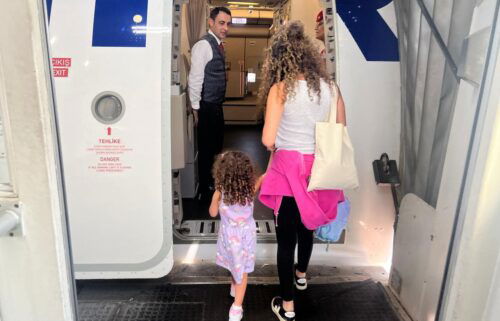 Ivan Watson's wife and daughter board a Turkish Airlines flight from Beirut Rafik al Hariri Airport on Sunday after cutting short a visit to Lebanon due to escalating tensions.