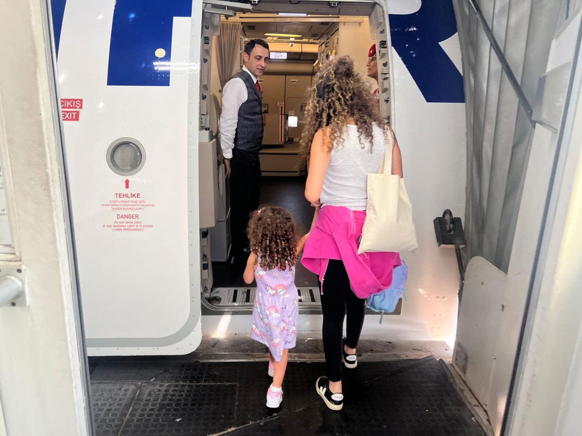 <i>Ivan Watson/CNN via CNN Newsource</i><br/>Ivan Watson's wife and daughter board a Turkish Airlines flight from Beirut Rafik al Hariri Airport on Sunday after cutting short a visit to Lebanon due to escalating tensions.
