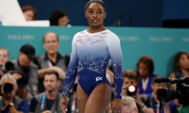 Simone Biles of United States reacts after falling off during her performance in the women's balance beam final on August 5.