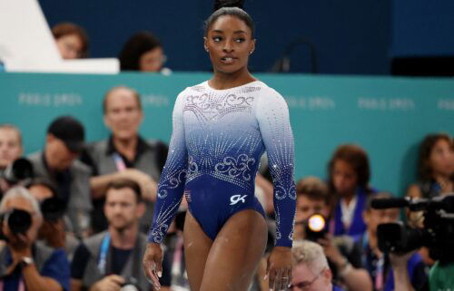 Simone Biles of United States reacts after falling off during her performance in the women's balance beam final on August 5.