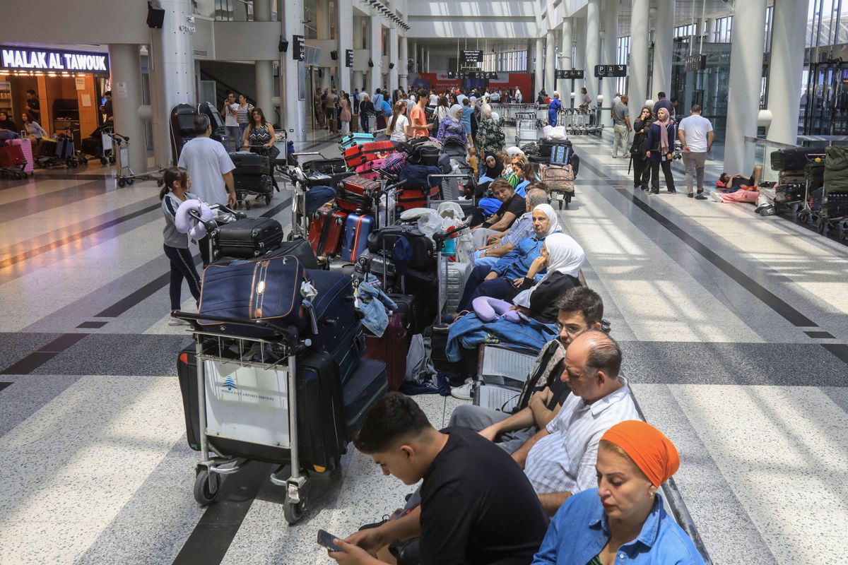 <i>AFP/Getty Images via CNN Newsource</i><br/>People await their flights at the Beirut airport's departure hall as urgent calls grew for foreign nationals to leave Lebanon