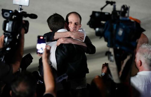 Reporter Evan Gershkovich receives an embrace following his release as part of a 24-person prisoner swap between Russia and the United States on Thursday