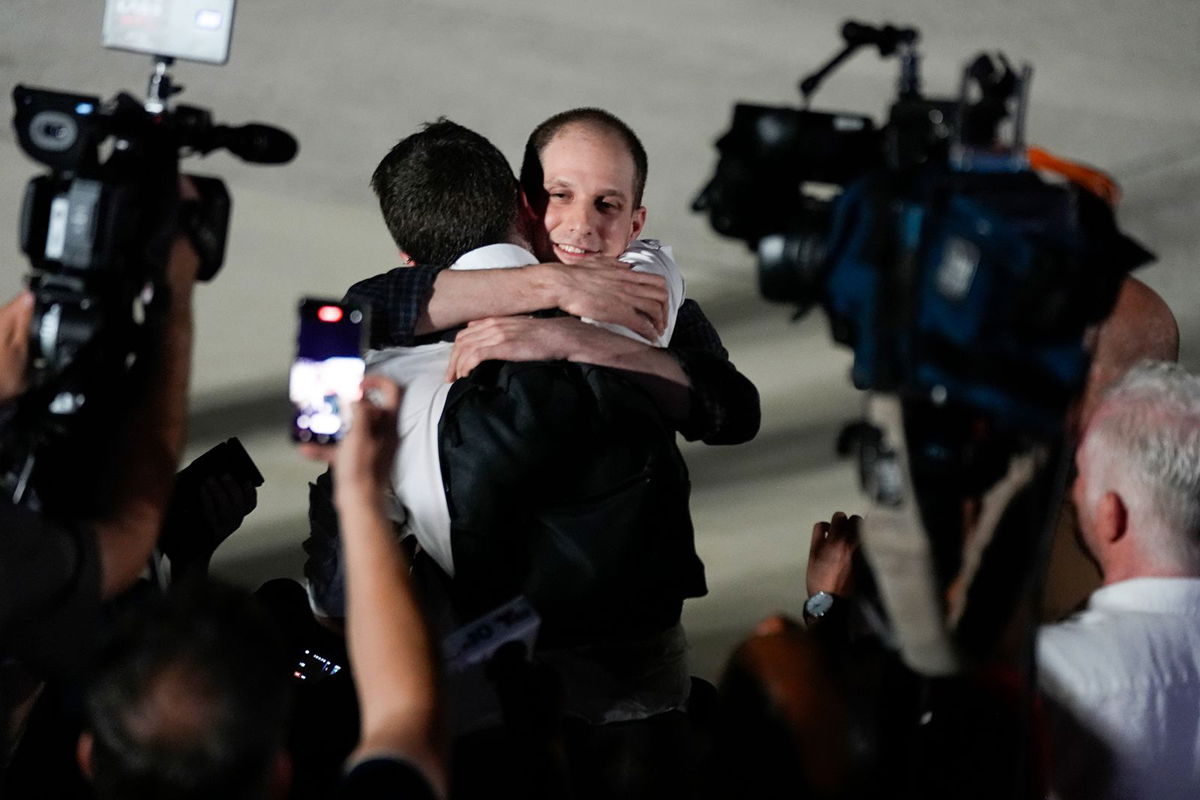 <i>Manuel Balce Ceneta/AP via CNN Newsource</i><br/>Reporter Evan Gershkovich receives an embrace following his release as part of a 24-person prisoner swap between Russia and the United States on Thursday