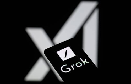 The Grok logo is being displayed on a smartphone with the X AI icon visible in the background in this photo illustration. A bipartisan group of secretaries of state blasted Elon Musk and his X platform on August 5 for providing “false information” about Vice President Kamala Harris’ supposed ineligibility to appear on the 2024 presidential ballot in several battleground states.