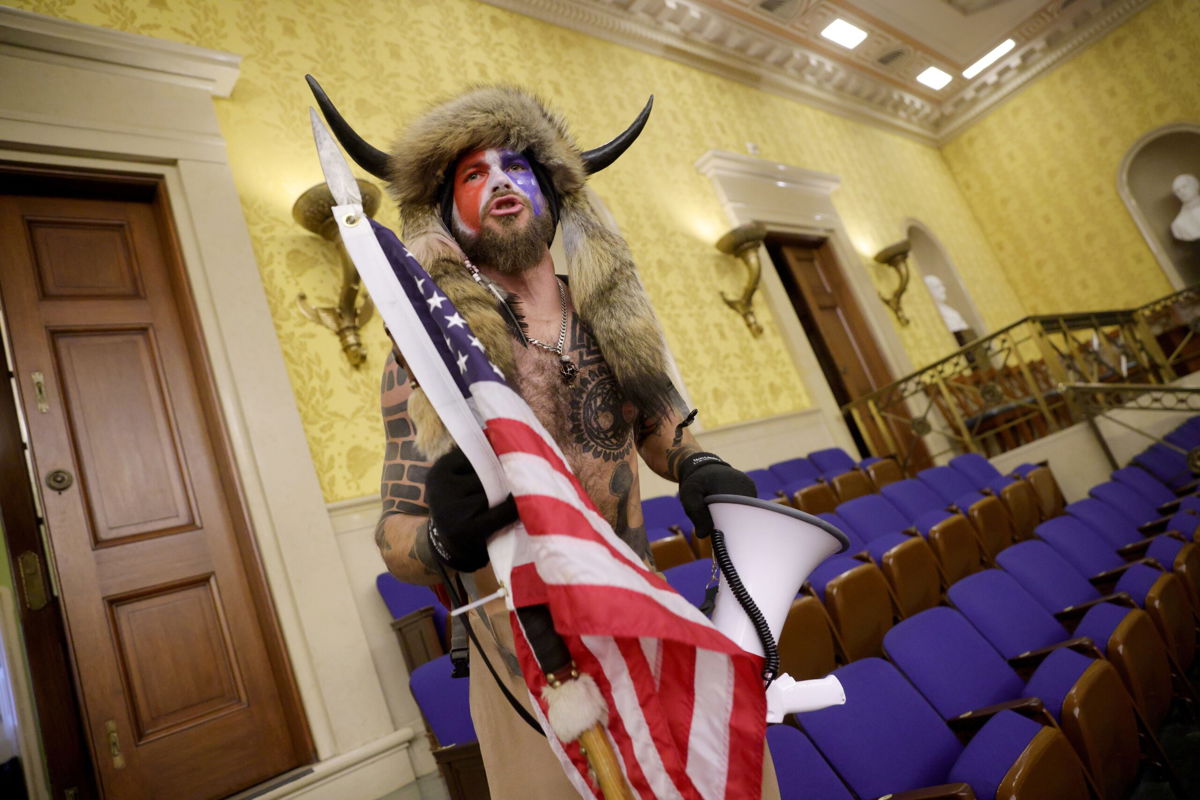 <i>Win McNamee/Getty Images/File via CNN Newsource</i><br/>Jacob Chansley inside the Senate Chamber on January 06