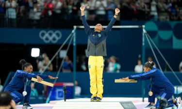 US gymnasts Simone Biles and Jordan Chiles celebrate gold medalist Rebeca Andrade of Brazil during the medal ceremony after the women's floor exercise final on August 5