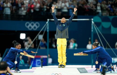 US gymnasts Simone Biles and Jordan Chiles celebrate gold medalist Rebeca Andrade of Brazil during the medal ceremony after the women's floor exercise final on August 5