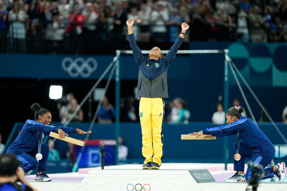 <i>Daniela Porcelli/Eurasia Sport Images/Getty Images via CNN Newsource</i><br/>US gymnasts Simone Biles and Jordan Chiles celebrate gold medalist Rebeca Andrade of Brazil during the medal ceremony after the women's floor exercise final on August 5