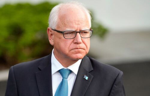 Minnesota Gov. Tim Walz listens as Maryland speaks to reporters after meeting with President Joe Biden