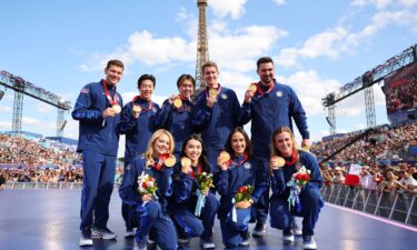 Members of the U.S. Olympic figure skating team celebrate with their gold medals from Beijing 2022.