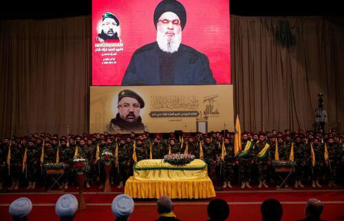 Hezbollah leader Hassan Nasrallah appears on a screen as he addresses his supporters