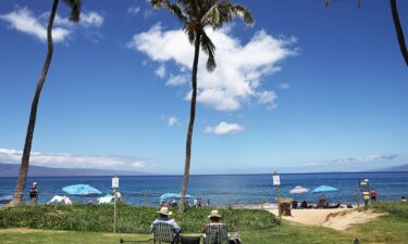 People gather along Kaanapali Beach on August 5