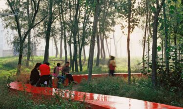 Visitors walk through Red Ribbon Park in Qinghuandao