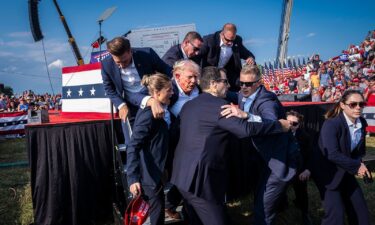 Secret Service agents remove former President Donald Trump from the stage in Butler