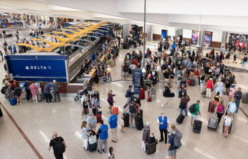 Delta Airlines passengers line up for agent assistance at Hartsfield-Jackson Atlanta International Airport on July 22