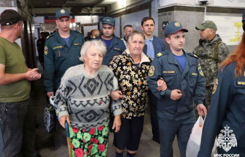 Russian authorities help residents during evacuation efforts at a railway station in Oryol