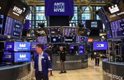 Traders work on the floor of the New York Stock Exchange (NYSE) ahead of the closing bell in New York City on August 5.