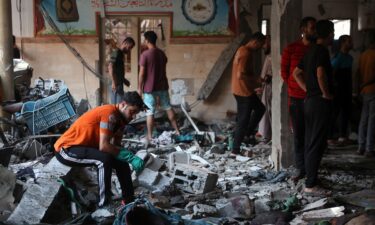 People check the damage inside a school which was being used as a temporary shelter for displaced Palestinians in Gaza City