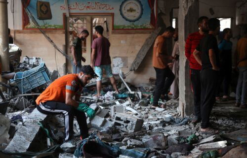 People check the damage inside a school which was being used as a temporary shelter for displaced Palestinians in Gaza City