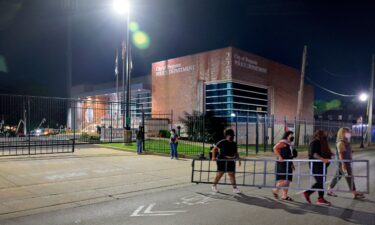 Protesters dismantle and remove a portion of a newly-installed gate outside the Ferguson