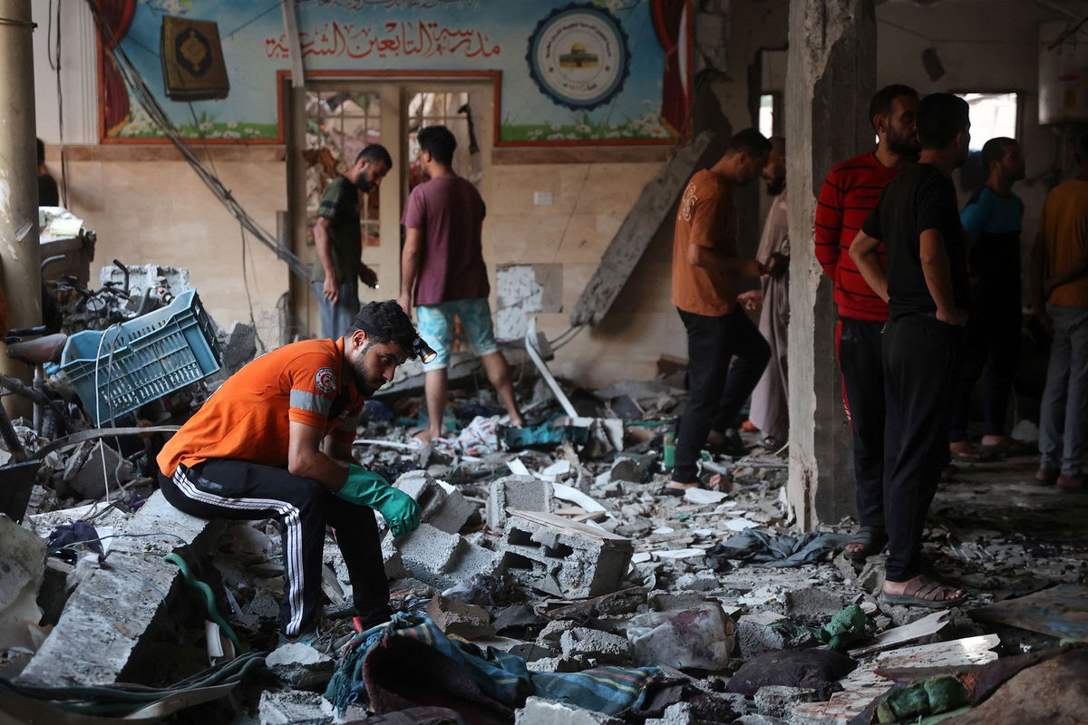 <i>Omar al-Qatta/AFP/Getty Images via CNN Newsource</i><br/>People check the damage inside a school being used as a temporary shelter for displaced Palestinians