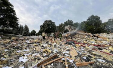 First responders walk through debris in the aftermath of a home explosion in Harford County