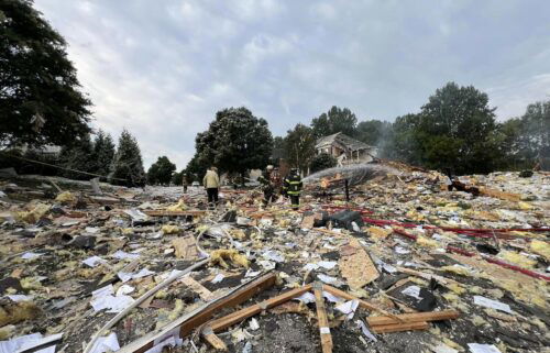 First responders walk through debris in the aftermath of a home explosion in Harford County