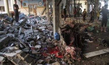 Palestinians inspect the damage after an Israeli strike on a school in Gaza City on Saturday.