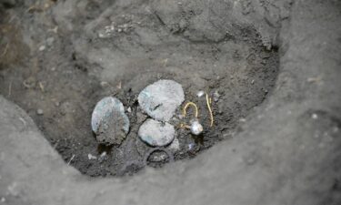 The woman was found holding coins and jewelry.