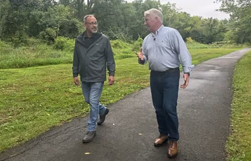 Pennsylvania voter Michael Pesce walks with John King in Bucks County.