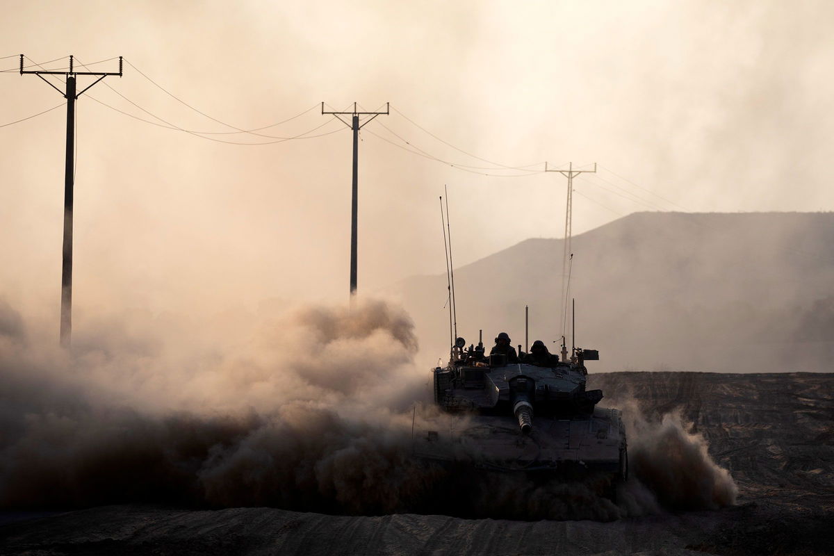 <i>Amir Levy/Getty Images via CNN Newsource</i><br/>Israeli soldiers ride in a tank along the border with the Gaza Strip on August 7