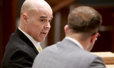 Robert Telles speaks with his attorney Monday on the first day of jury selection.