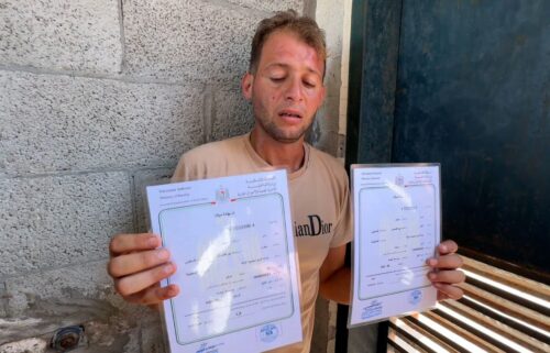 Mohammad Abu Al Qumsan holding the birth certificates for his twins