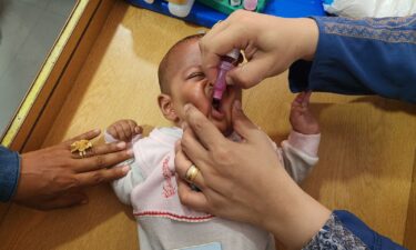 A medical team from the Palestinian Red Crescent vaccinates a child against poiio as part of a routine campaign at Al-Amal Hospital in Khan Younis on August 22.