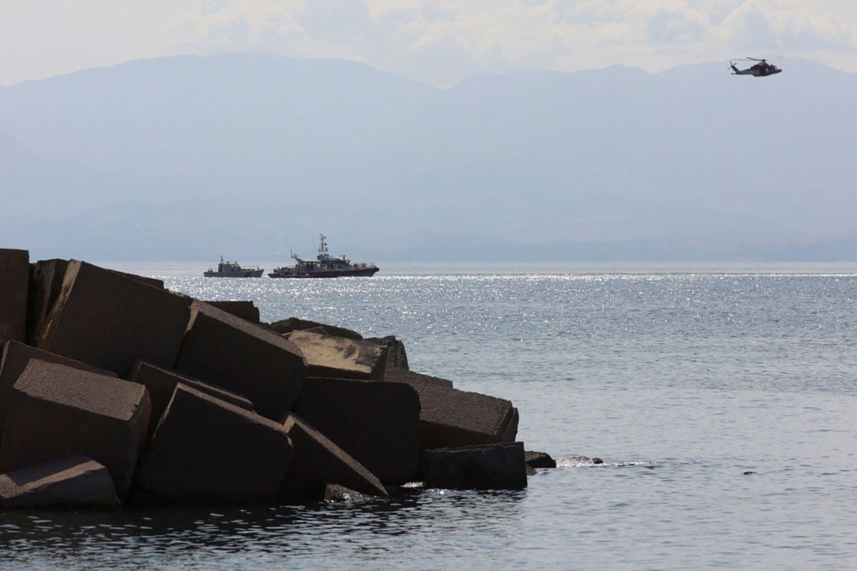 <i>Igor Petyx/Reuters via CNN Newsource</i><br/>Emergency crews search the coast off the Italian port of Porticello